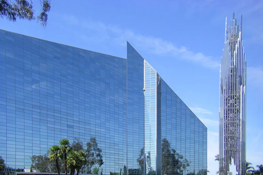 Christ Cathedral, the glass former Crystal Cathedral, and its stainless-steel bell tower against a blue sky in Garden Grove