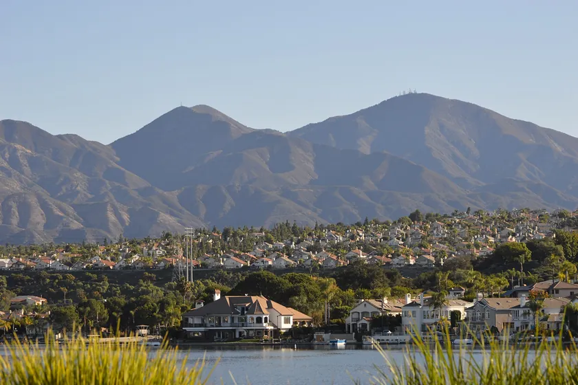 Lake Mission Viejo and its lakeside homes below the twin peaks of Saddleback in the Santa Ana Mountains