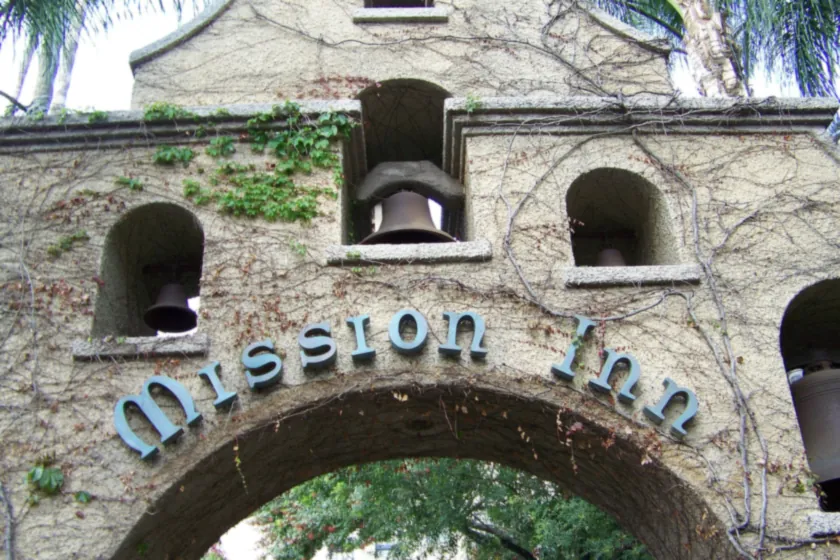 The ivy-covered bell arch of the historic Mission Inn in downtown Riverside, with Mission Inn spelled across it