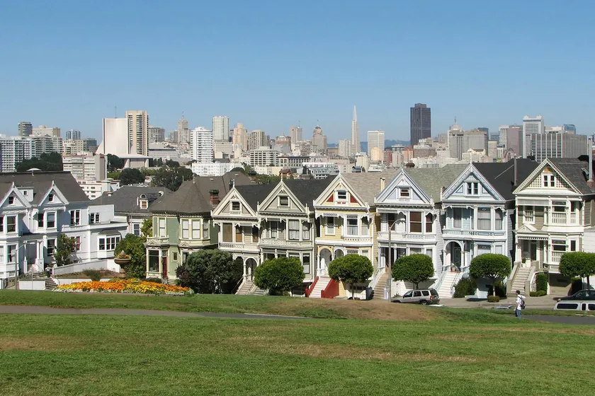 The Painted Ladies, a row of Victorian houses facing Alamo Square, with the downtown San Francisco skyline behind