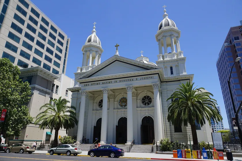 The twin domed bell towers and columned front of the Cathedral Basilica of St. Joseph in downtown San Jose