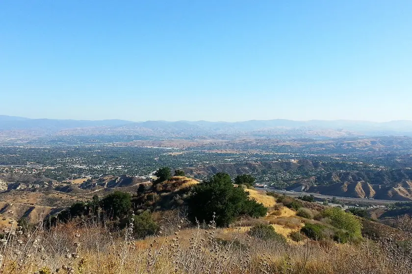 A wide view from a hilltop over the Santa Clarita Valley's neighborhoods and golden, brush-covered hills