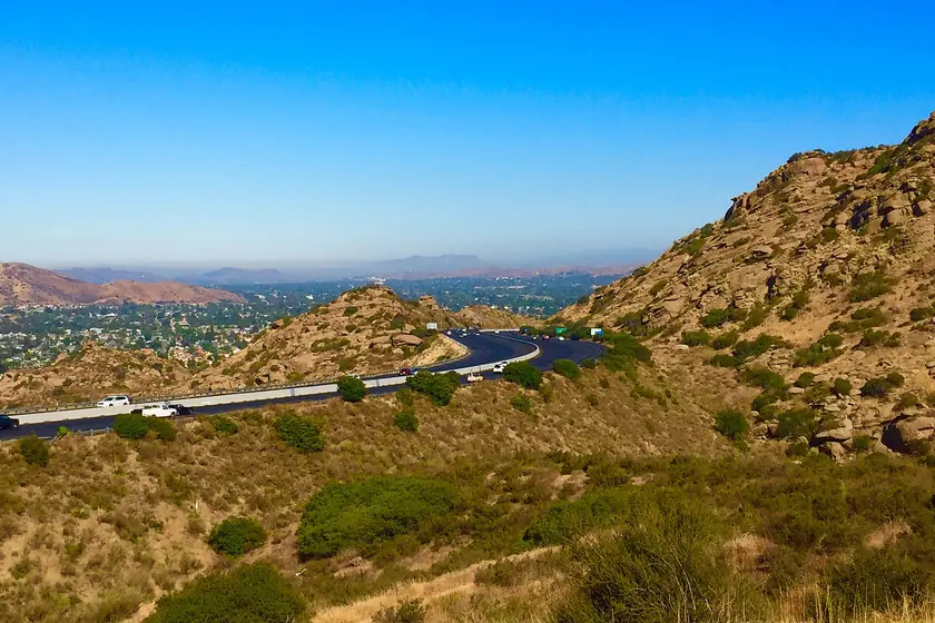 The freeway curving down through the rocky, brush-covered Santa Susana Pass toward Simi Valley