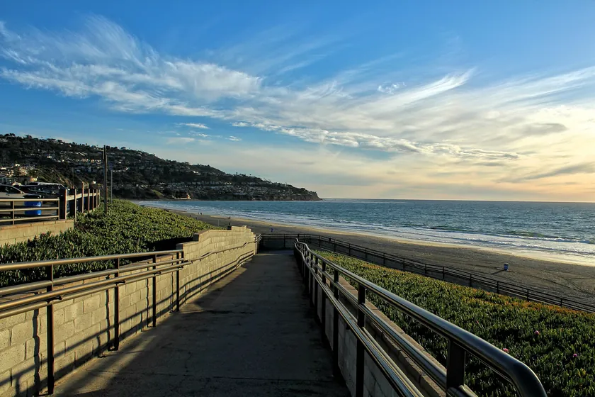A walkway along the bluff down to Torrance Beach at golden hour, with the Palos Verdes Peninsula on the horizon
